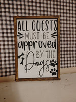 All guests must be approved by the dogs Sign