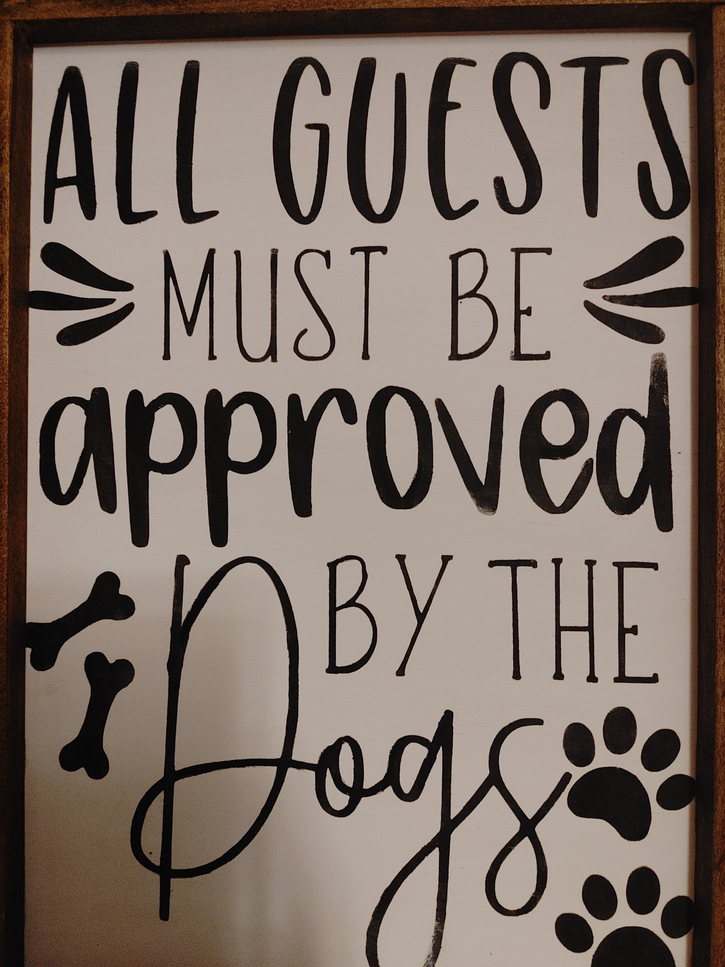 All guests must be approved by the dogs Sign